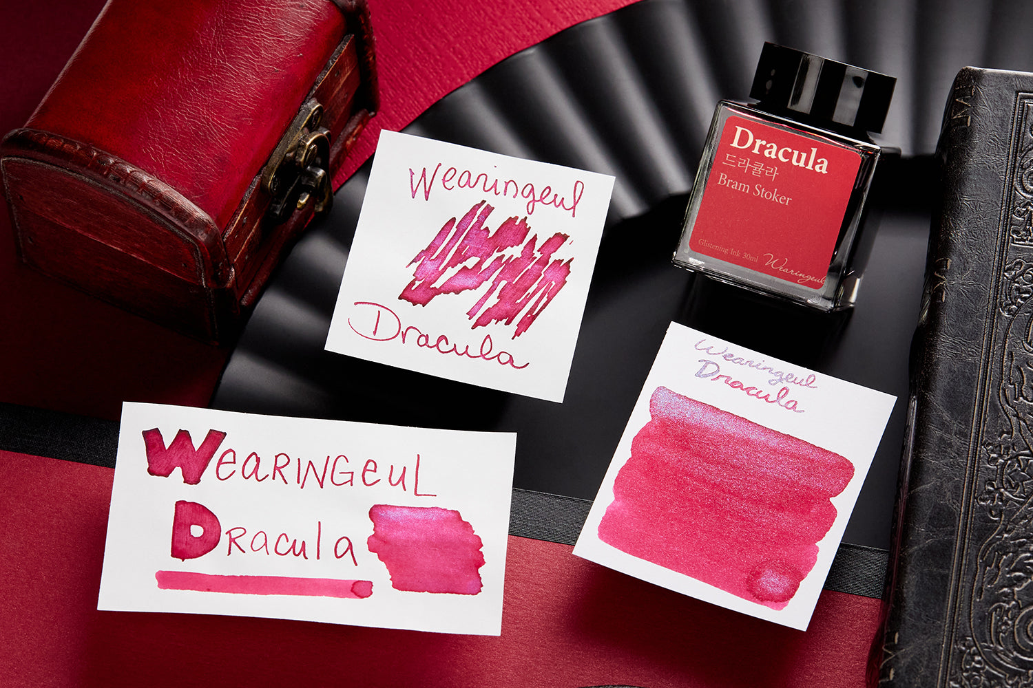 Wearingeul Dracula Fountain Pen Ink writing sample, bottle and swab on black and red textured background