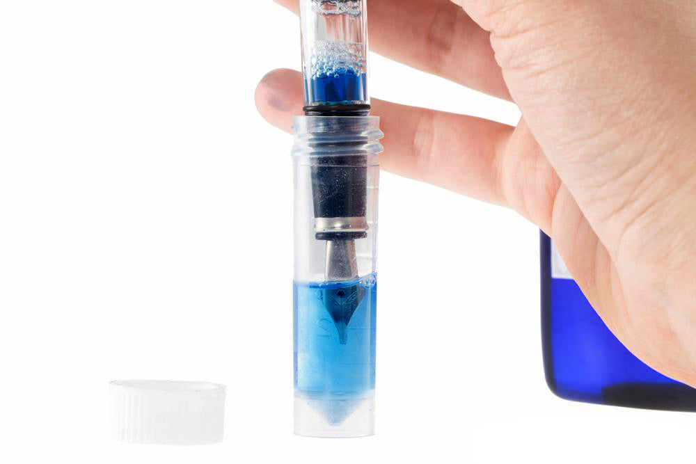 photo of pen going into empty vial
