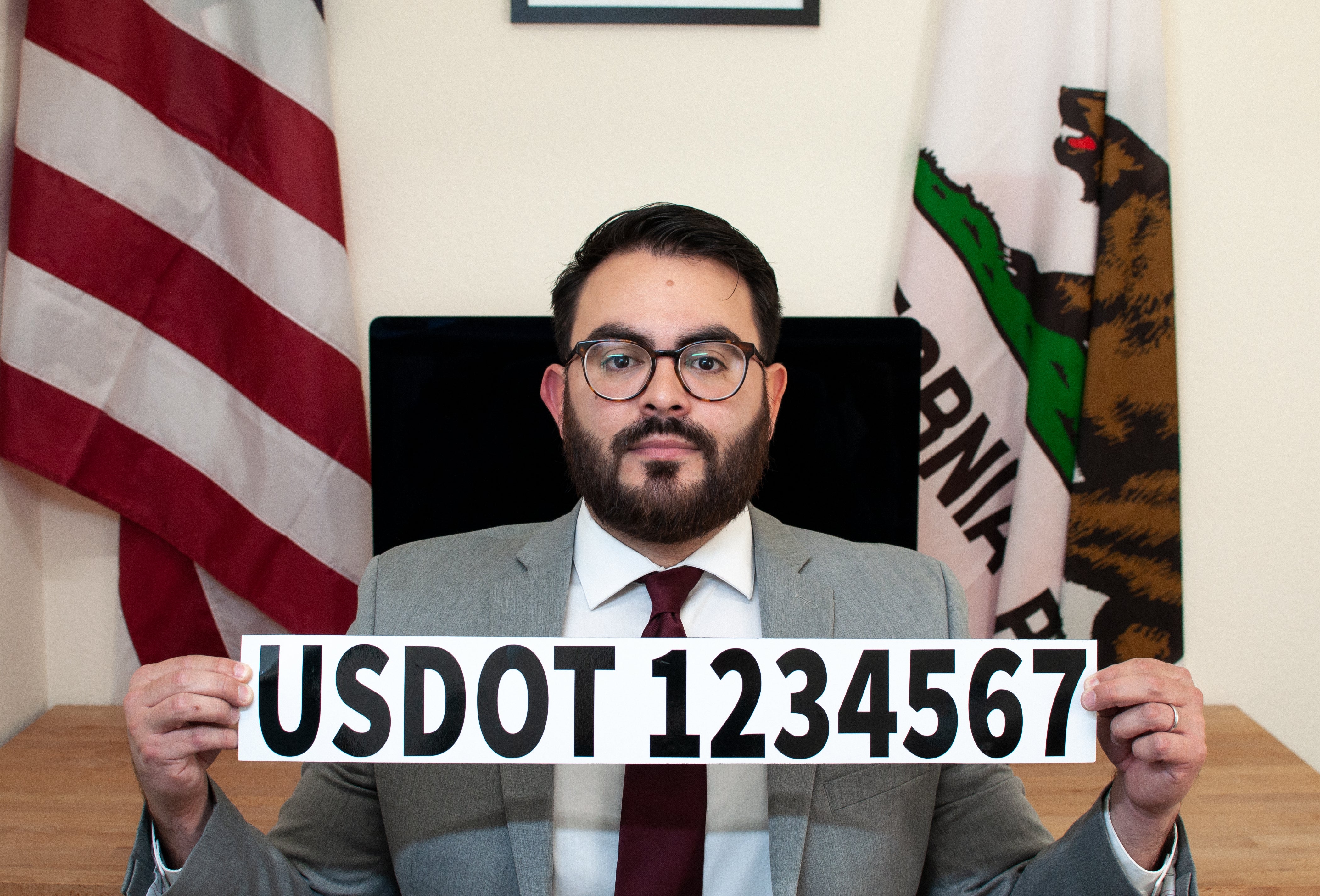 man holding example of usdot number magnet