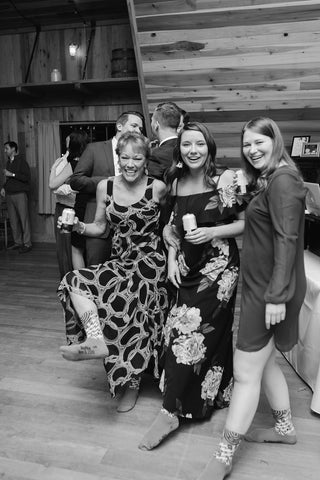 women dancing at a wedding in their sock feet