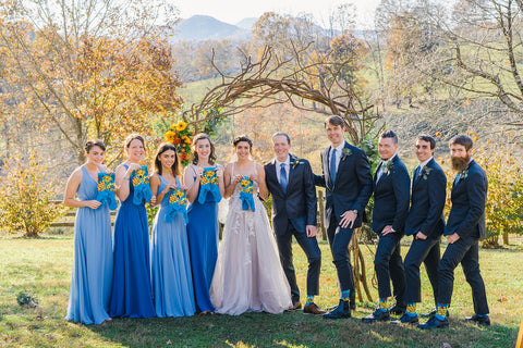 A wedding party with ladies in blue show off blue custom socks