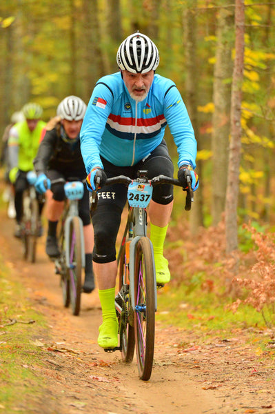 Shane and Hope Cooper of DeFeet cycling on a trail in the Michigan BWR cycling event
