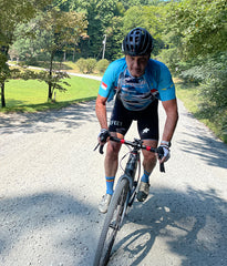 male cyclist riding an e-bike on a gravel road