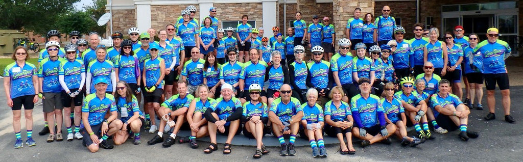 a team of cyclists in blue and lime green jerseys wearing matching custom socks