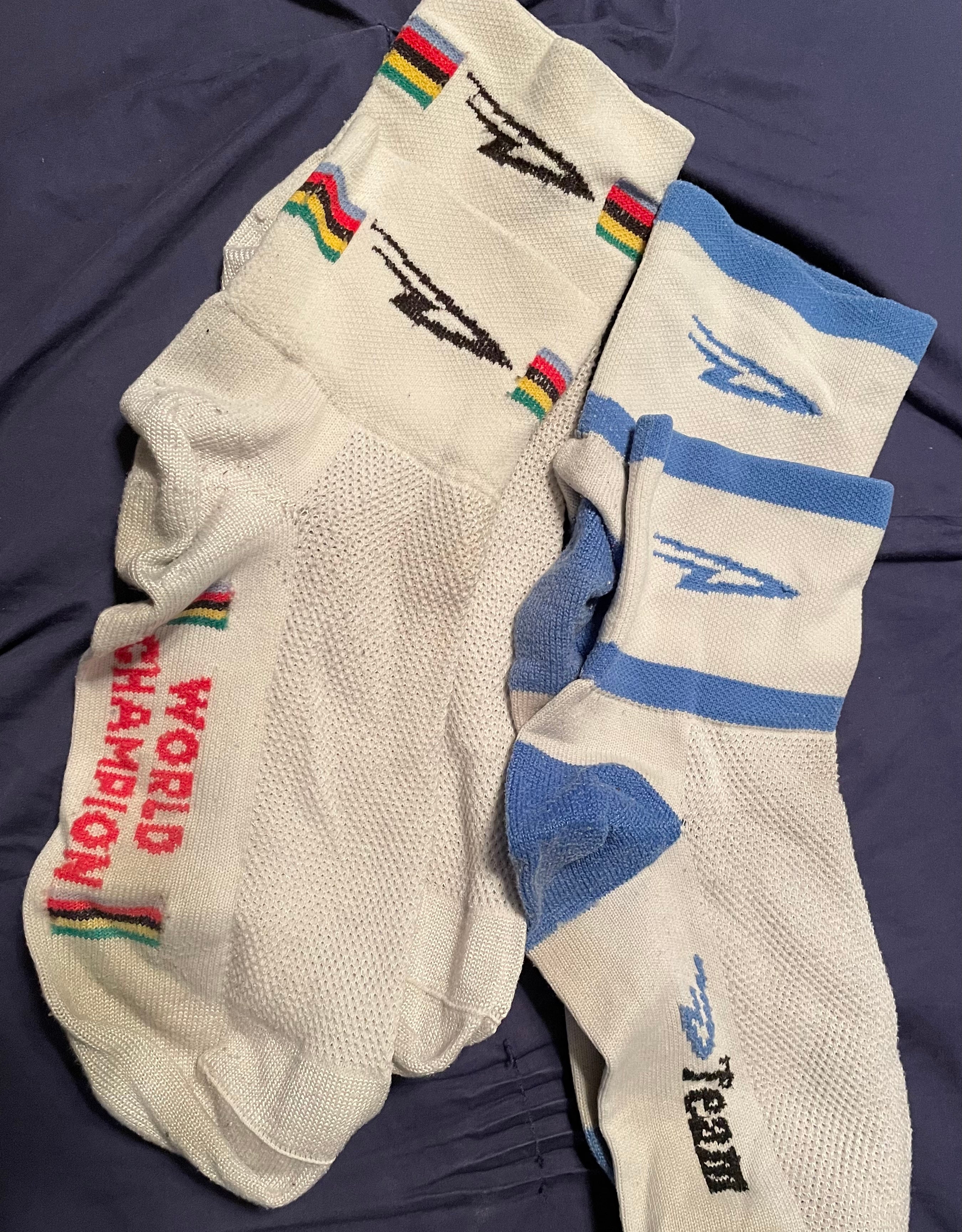 two pairs of heavily worn DeFeet Aireator cycling socks