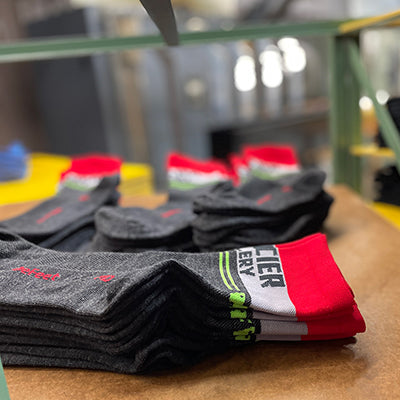 Custom DeFeet cycling socks stacked on a table