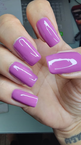 A rich plum purple shade that is a 2023 fall nail color trend