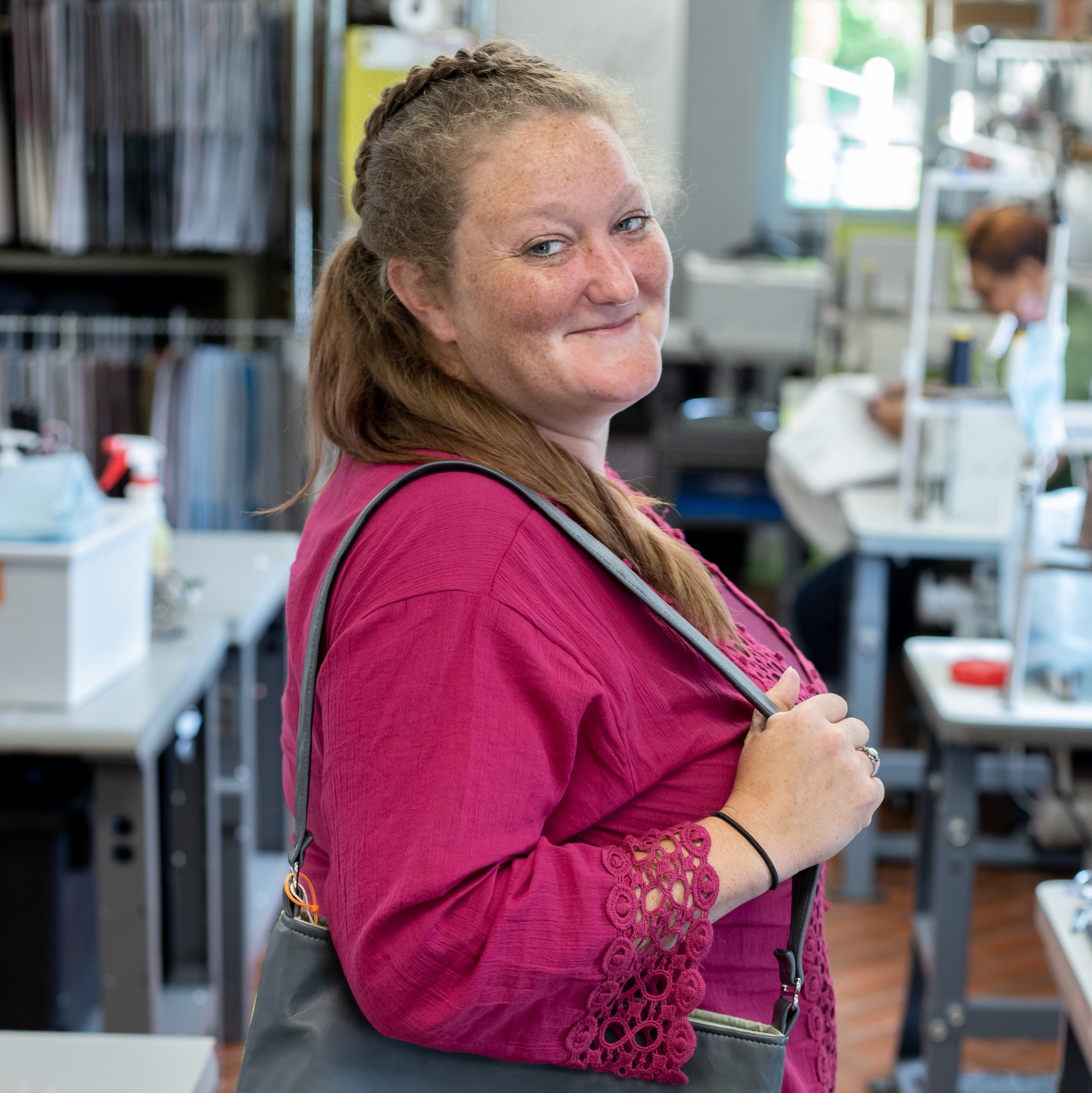 Jillian holds a bag and smiles at the camera