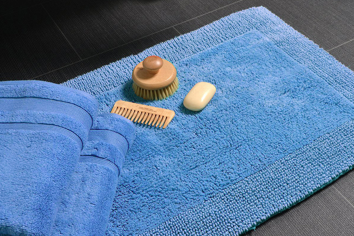 Cornish Blue Bath Mat and Towels on Bathroom Floor