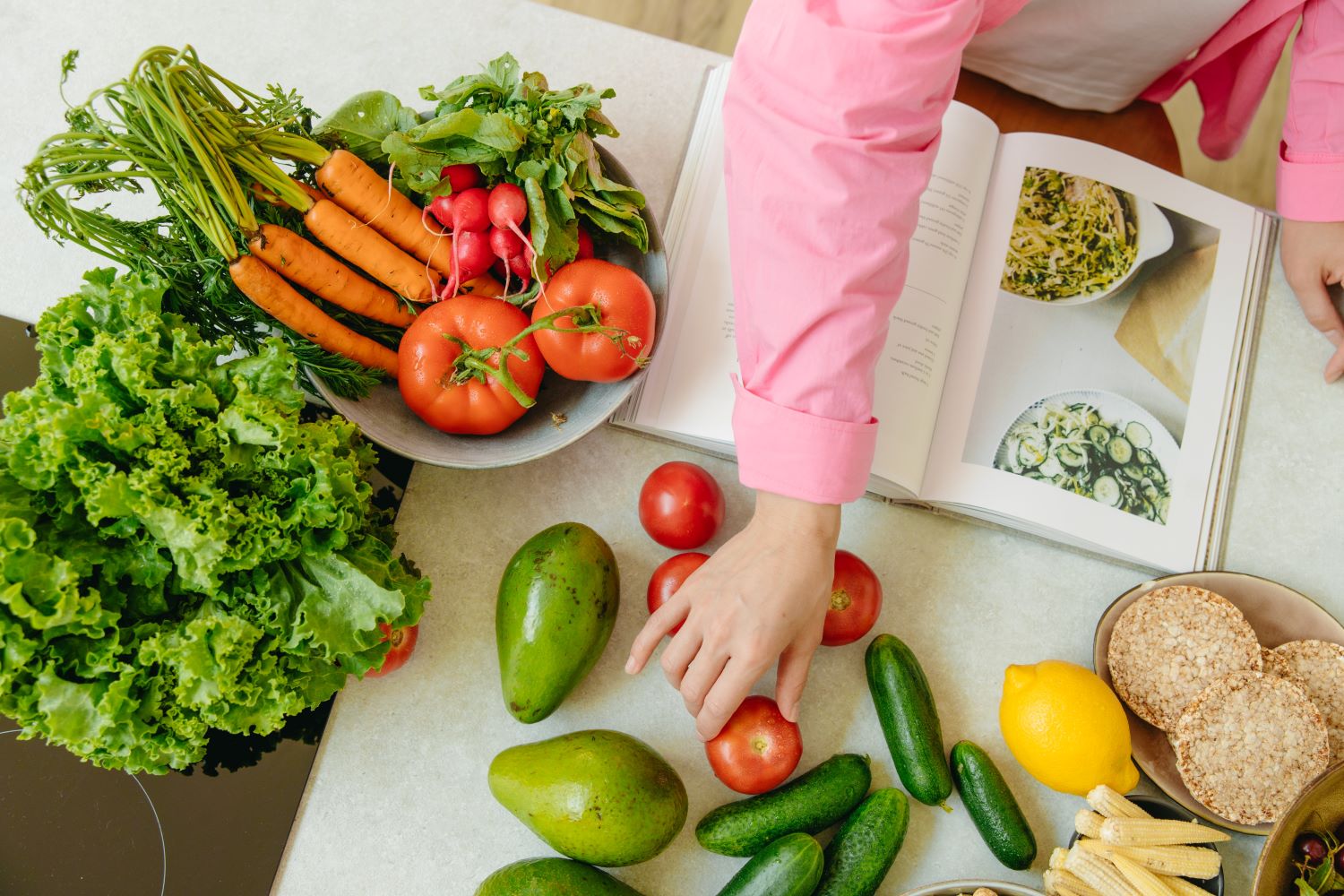 Fresh Vegetables and Fruits on the Table next to a Recipe Book