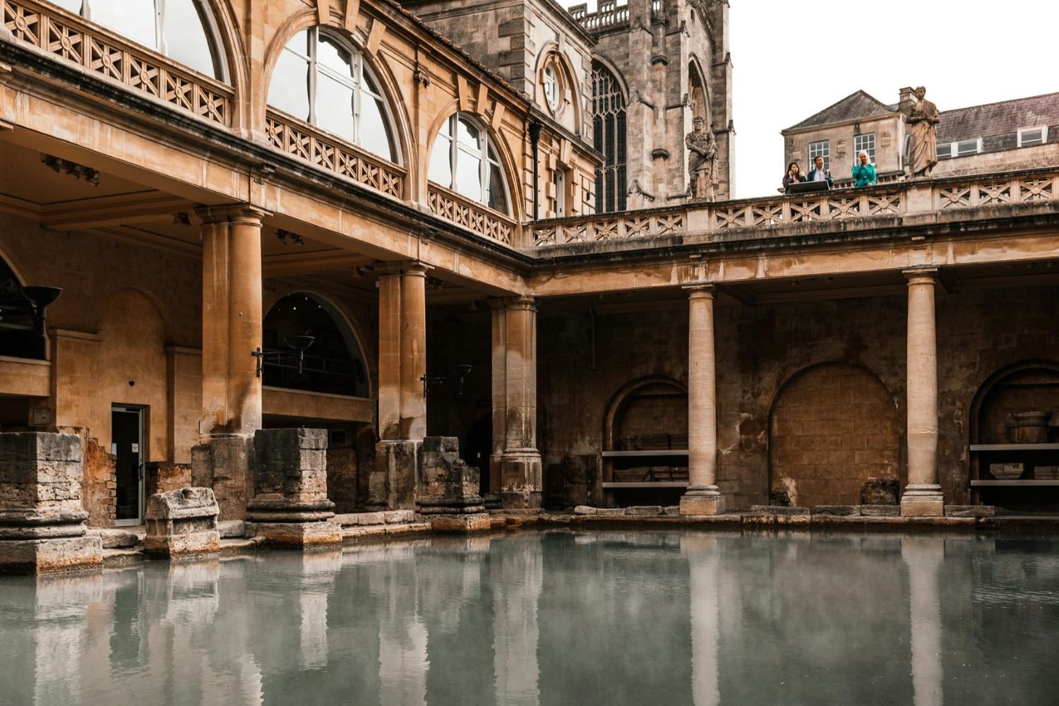 Old temple facade reflecting in Roman Baths in England