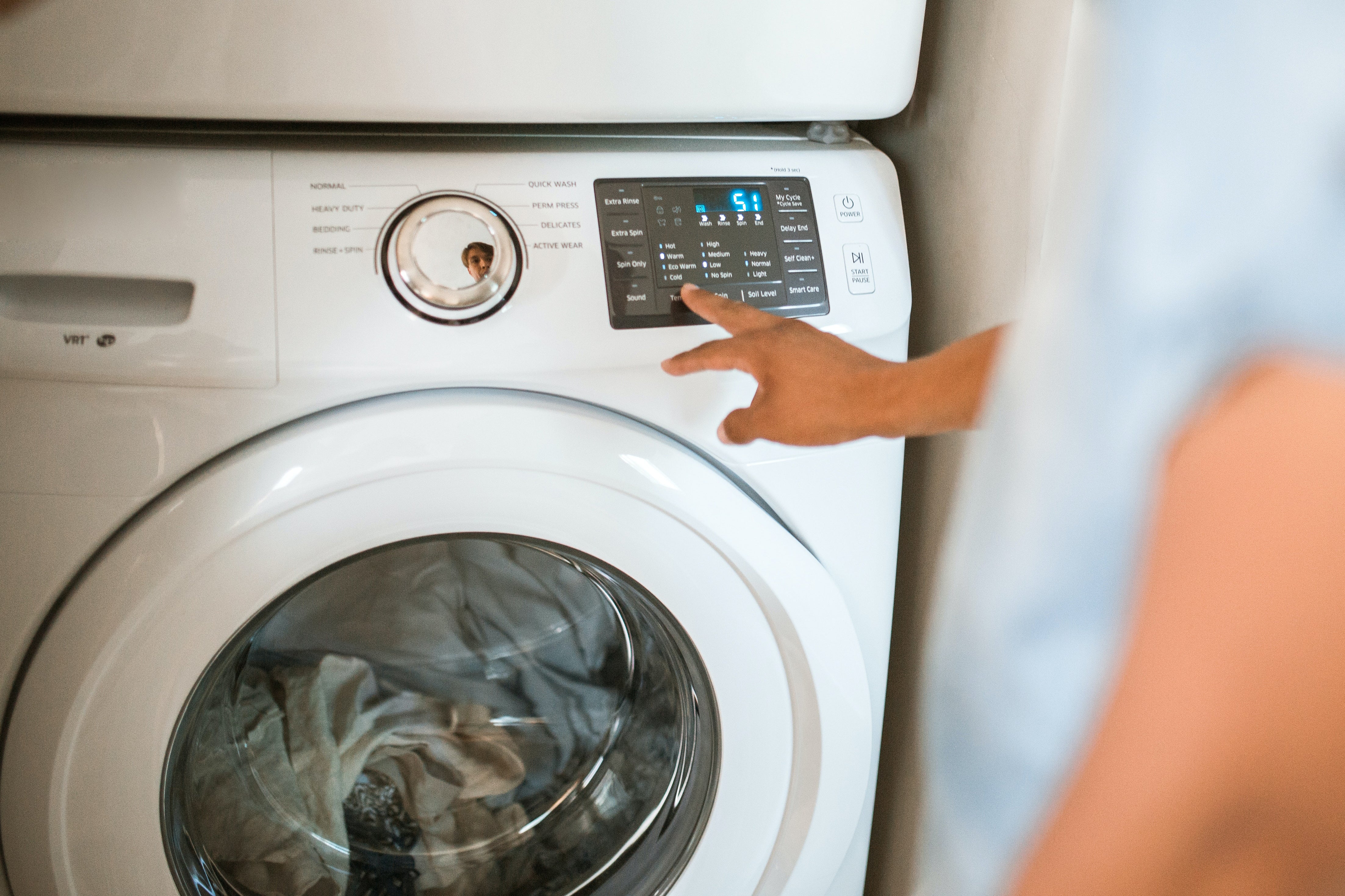 Person using washing machine