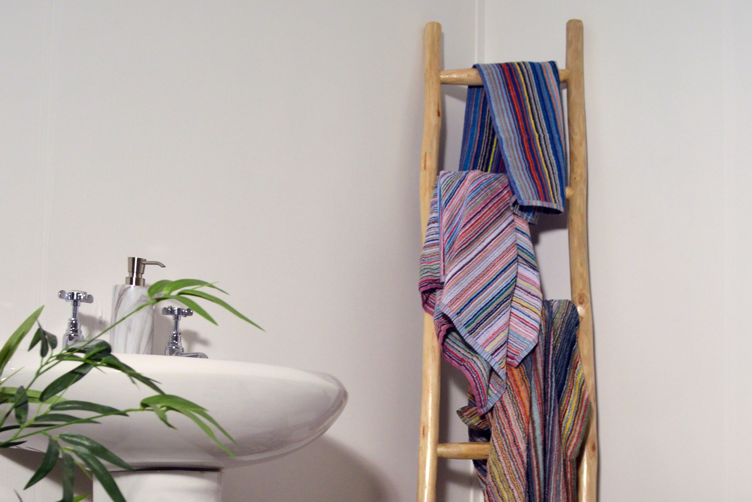 Remnant Yarn Recycled Cotton Towels hung on a ladder in a Bathroom