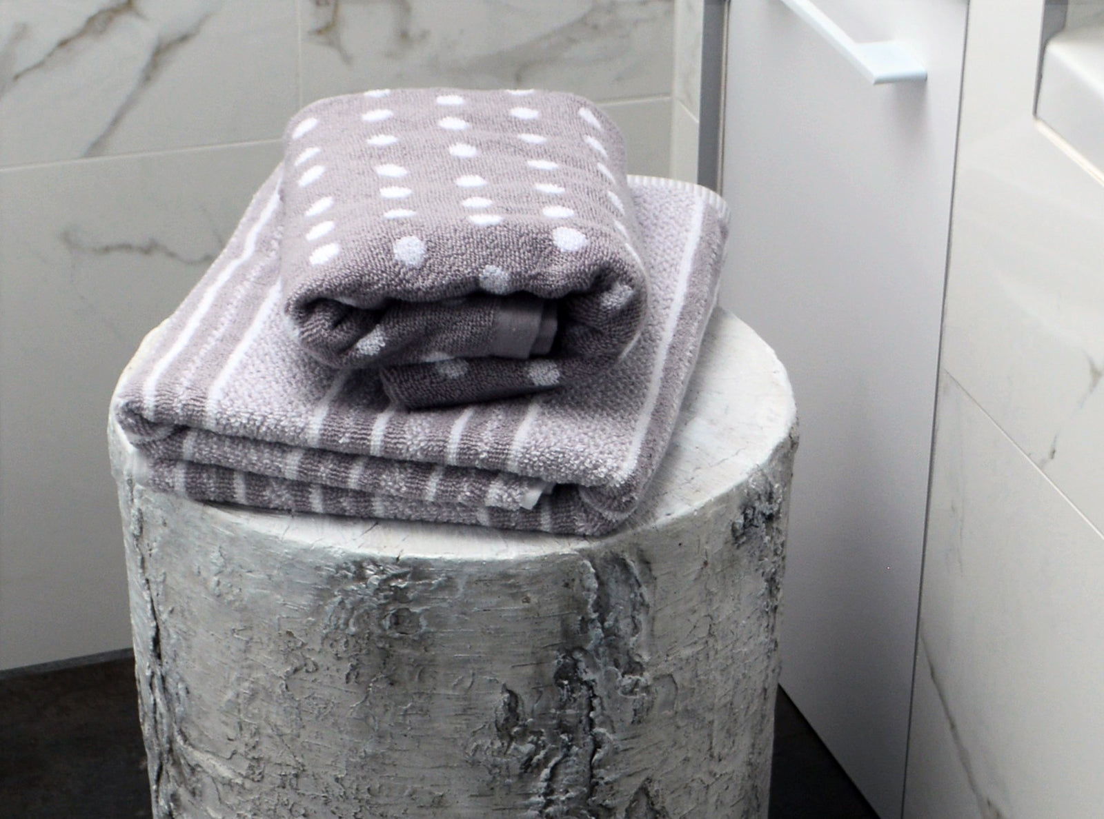 Striped and Polka Dot Towels folded in Bathroom