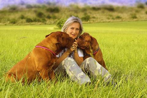 older woman with dogs who love her