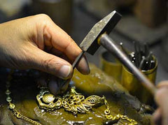 Close up craftsman working on gold jewelry