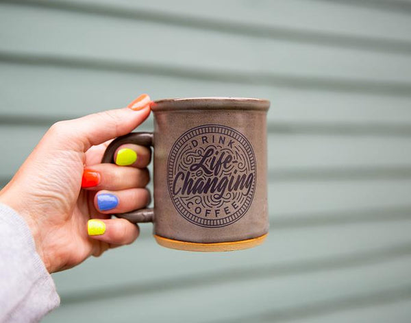 hand holding a mug of coffee