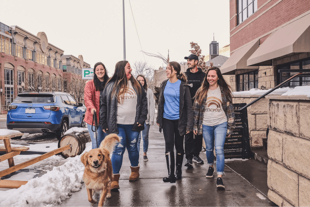 people walking down a street wearing Generous-branded clothing