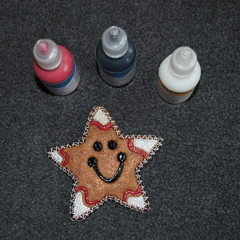 Picture of machine applique'd Christmas cookie star with 3D paint for mixed media at Sew Inspired by Bonnie