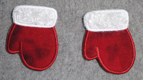 Picture of two free-standing machine applique mittens side by side.