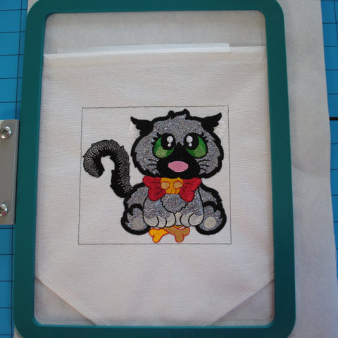 Picture of machine embroidered Halloween cat in hoop.