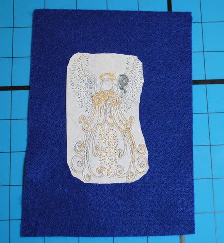 Picture of backside of machine embroidered angel showing stabilizer at Sew Inspired by Bonnie