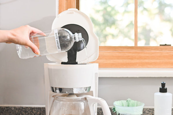 Pour-the-vinegar-water-solution-into-the-coffee-pot's