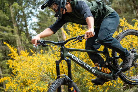 Devite Bikes  at Fife Cycles. Rider nailing down a hill on the green Highlander