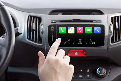 man sitting in a car with infotainment systems