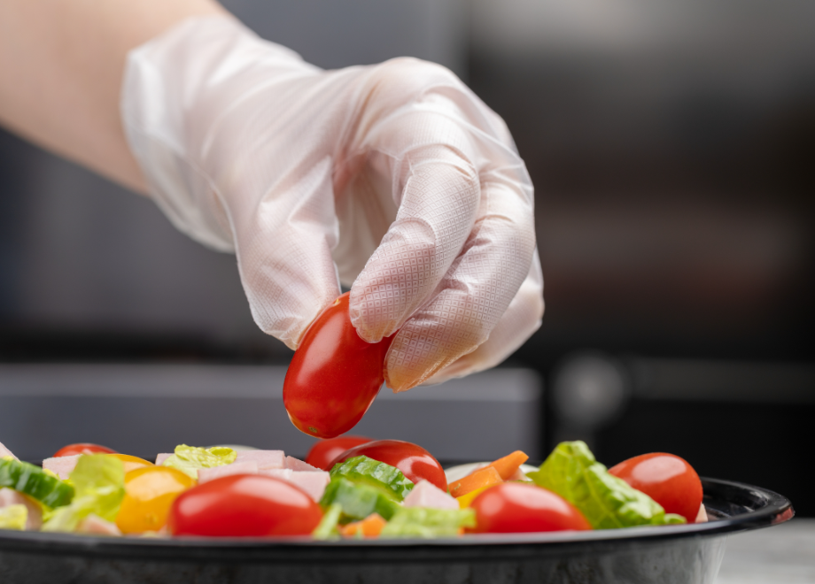 person wearing c2 hybrid gloves and prepping a salad