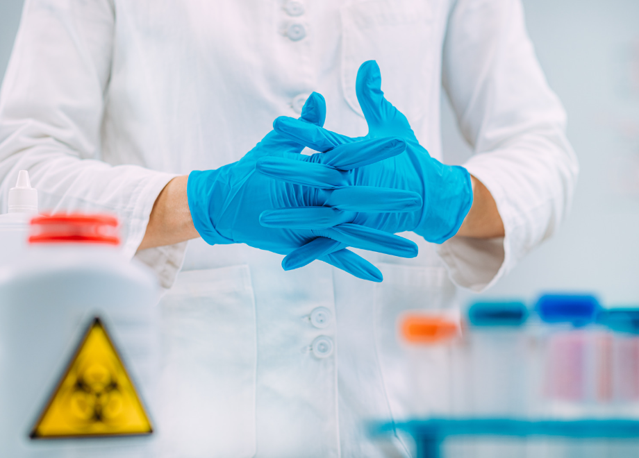 person wearing blue nitrile gloves in a laboratory