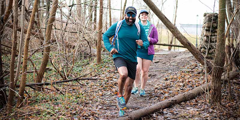 Man smiling while trail running