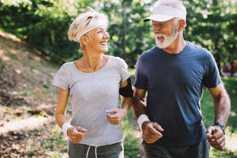 Pair of people smiling outside in activewear