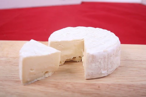 round of brie cheese with a slice removed