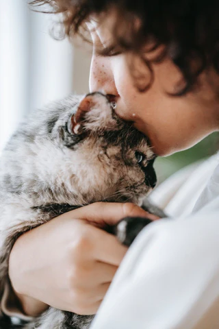 woman kissing her cat