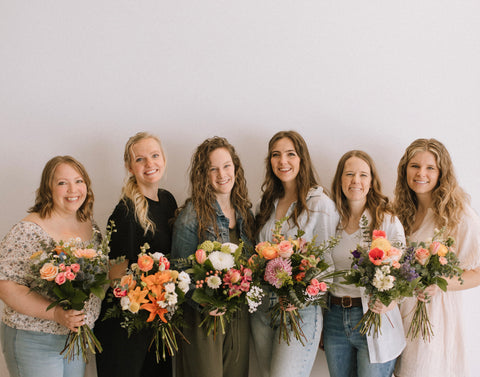 our team with bouquets from our summer