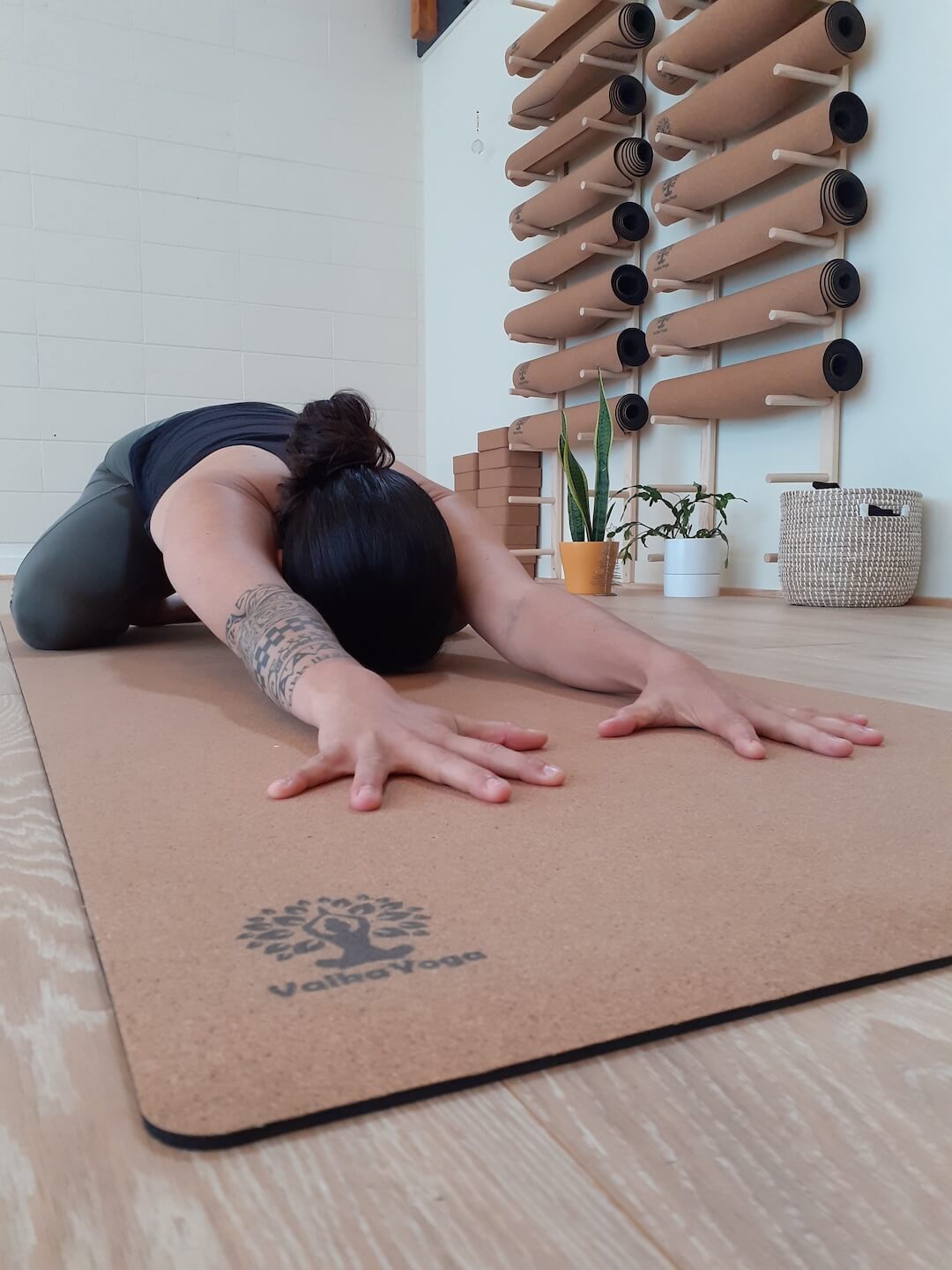 Charlotte Genton from NowBreathe Studio NZ stretching on her yoga mat