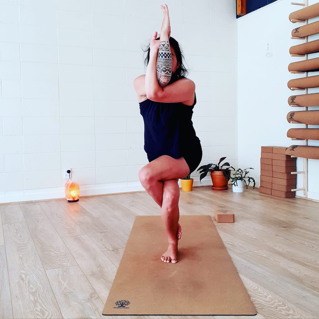 Charlotte Genton eagle pose on yoga mat in studio in NZ