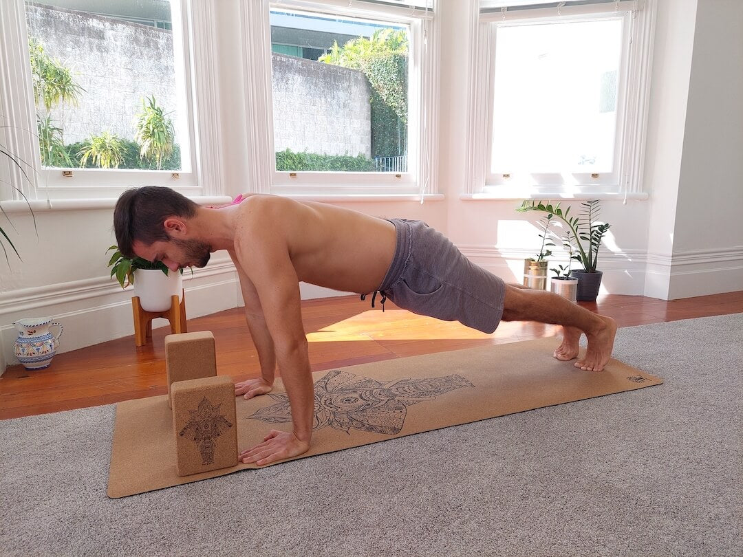 Jaroslav demonstrating plank pose on cork yoga mat