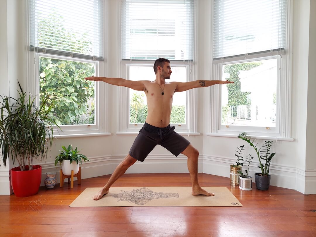 Jaroslav demonstrating warrior pose on cork yoga mat