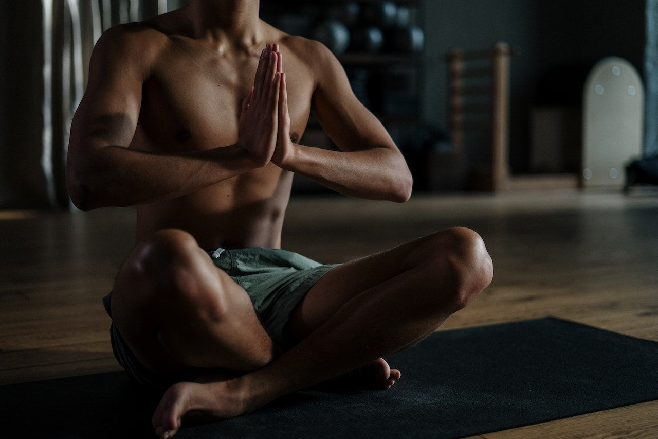 Man practicing yoga - seated in prayer pose