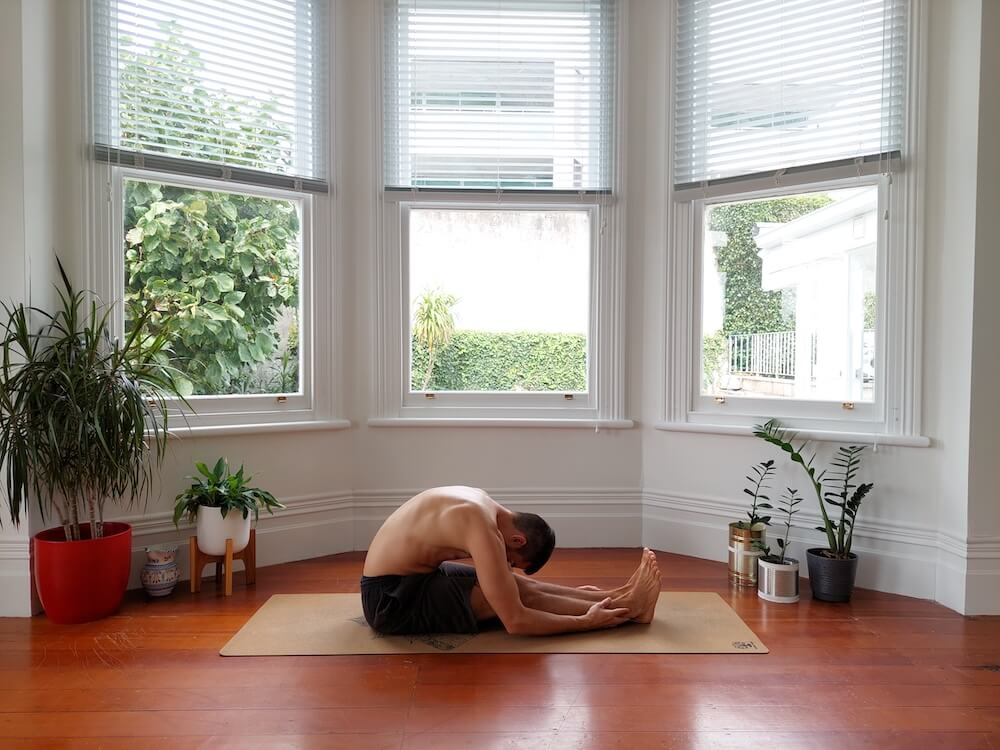 Jaroslav performing yoga seated forward bend stretch