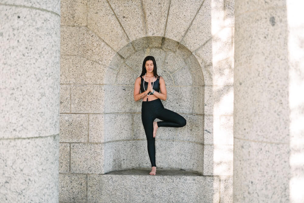 Yogini demonstrating yoga tree pose