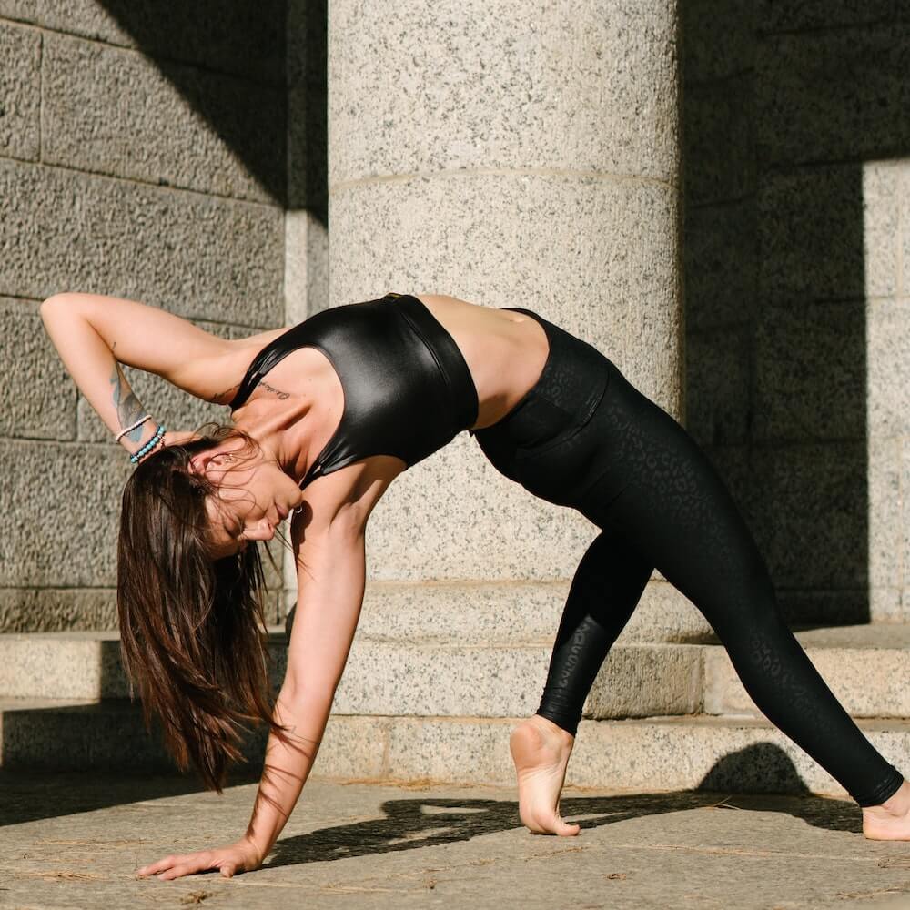 Yogini practising yoga wild thing pose