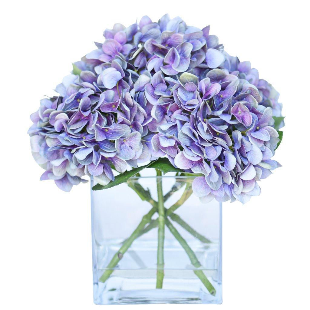 purple artificial flowers in vase