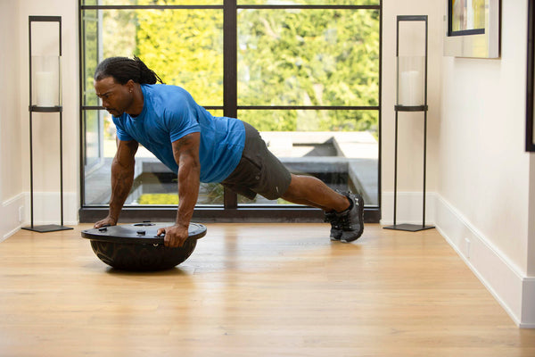 Plank on a half ball balance trainer 