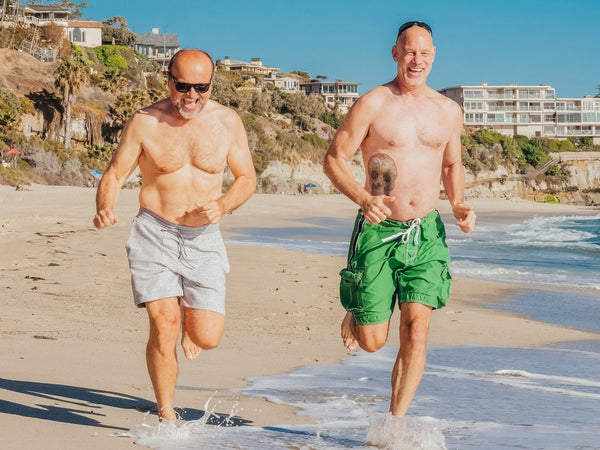 Two men running on the beach