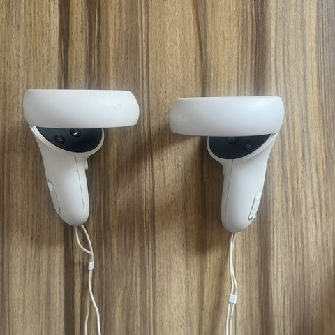 a pair of meta quest 2 touch controllers