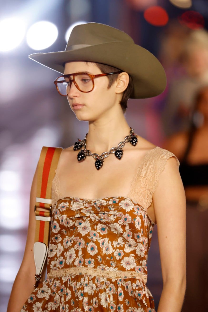 A Gucci model showing off this elegant and wide brimmed cowboy hat to the delight of the onlookers of the fashion show.