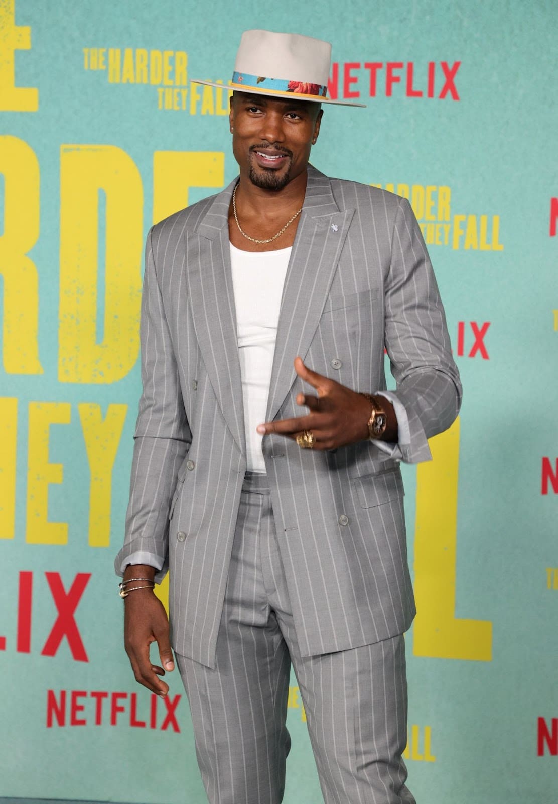 Serge Ibaka wore a white wide brim hat with a floral hat band and grey pinstripe suit at the premiere of The Harder They Fall in Los Angeles (Rich Fury/Getty Images).